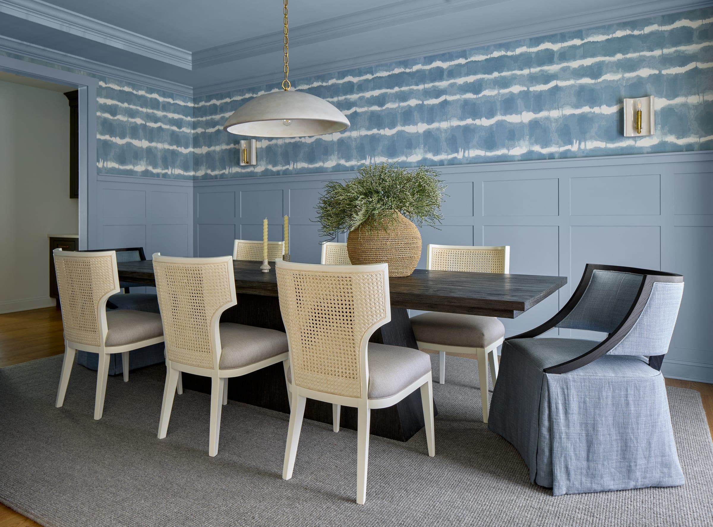 Blue dining room with wallpaper, window treatments and layered coastal furnishings in a Westfield, NJ home by Ellie Mroz Design.