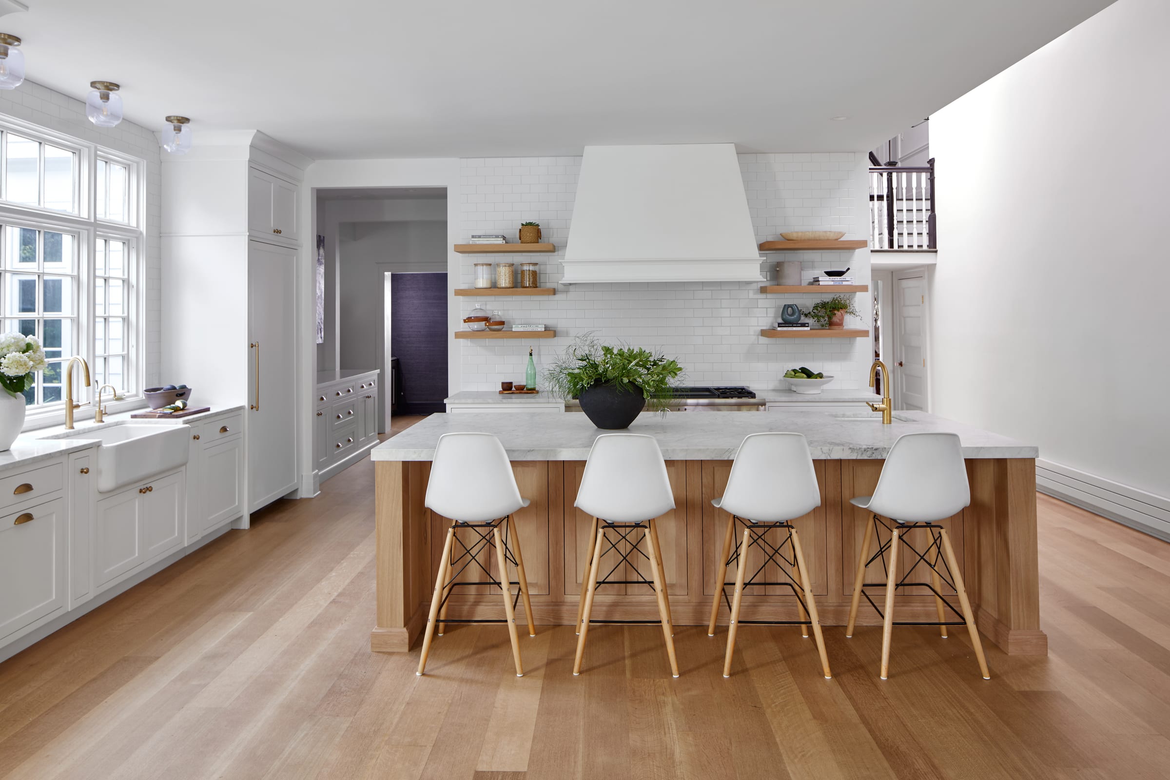 White kitchen with a white hood and natural open shelves in a historic Westfield, New Jersey home by Ellie Mroz Design.